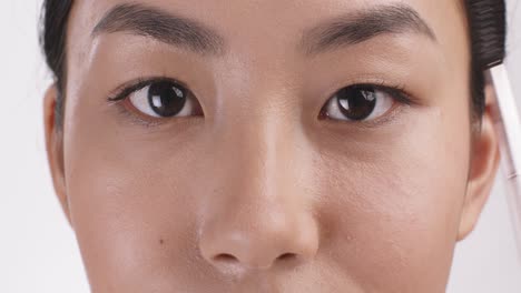 woman applying eyebrow makeup