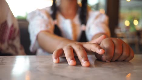 child's hands on a marble table