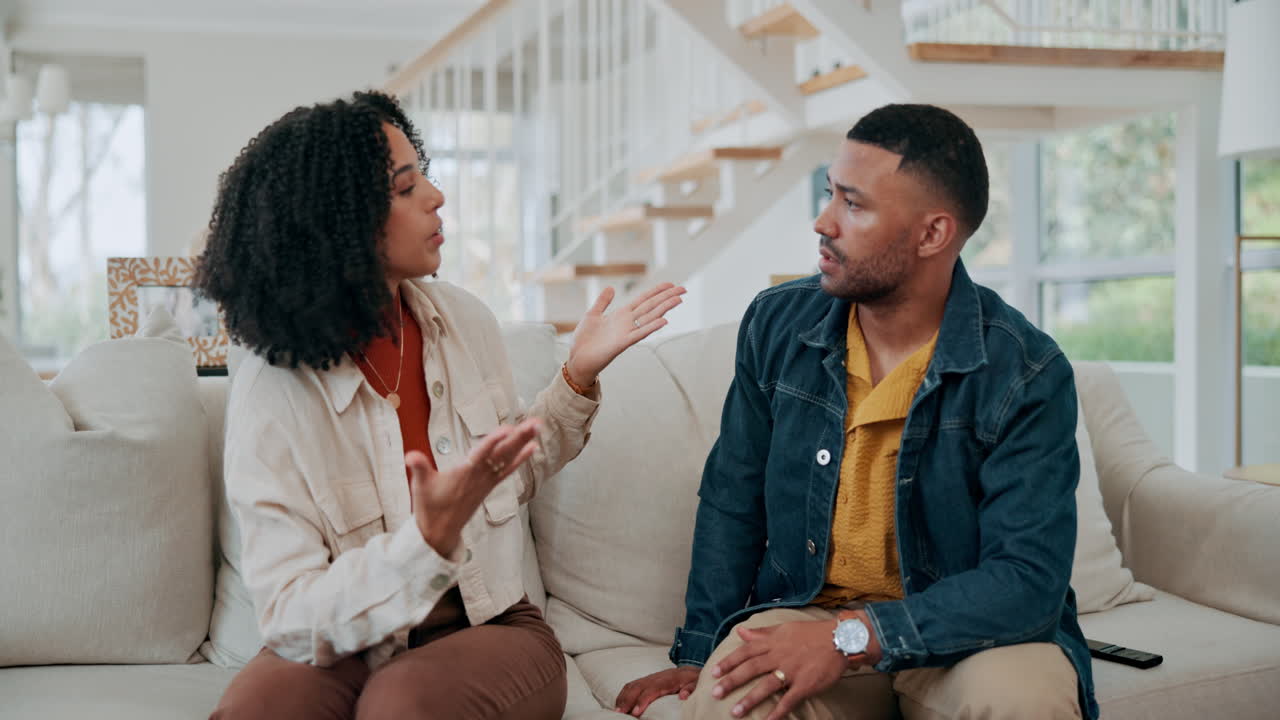 Couple having a serious discussion in their living room