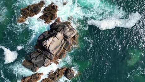 Overhead-birds-eye-view-rocks-in-clear-blue-sea-Jersey-channel-islands