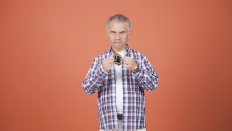 penniless man looking at his empty wallet.