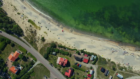 the wonderful skyview in byxelkrok, öland, sweden with clear green ocean surrounding the village - aerial shot