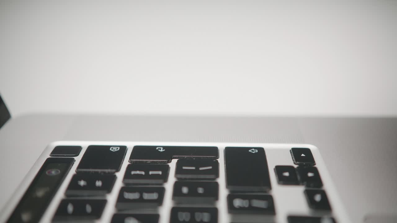A macro shot shows a single finger pressing the Tab key on a laptop keyboard. A concept of user input, digital navigation, data entry, and executing a computer command