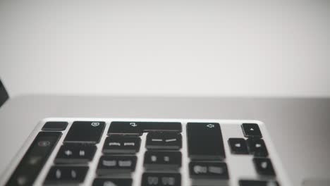 a macro shot shows a single finger pressing the tab key on a laptop keyboard. a concept of user input, digital navigation, data entry, and executing a computer command