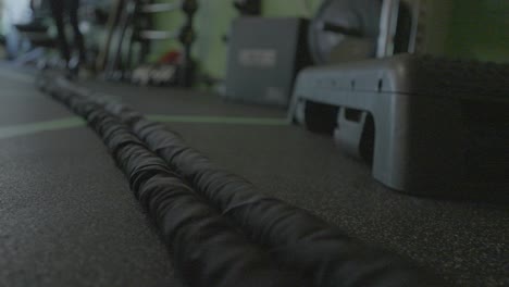 a woman doing rope exercises inside a gym