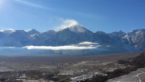 Aerial-view-of-Sierra-Nevada-mountain-range-snowdrift-on-a-sunny-day,-California,-USA