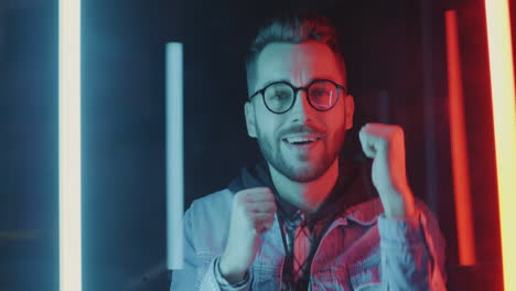 excited man celebrating in neon light