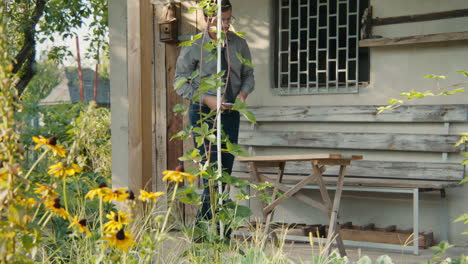 man working on wooden furniture outdoors