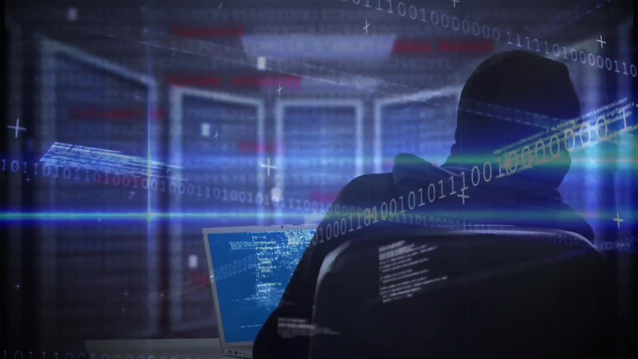 Animation of binary coding processing over caucasian male computer hacker in balaclava using laptop