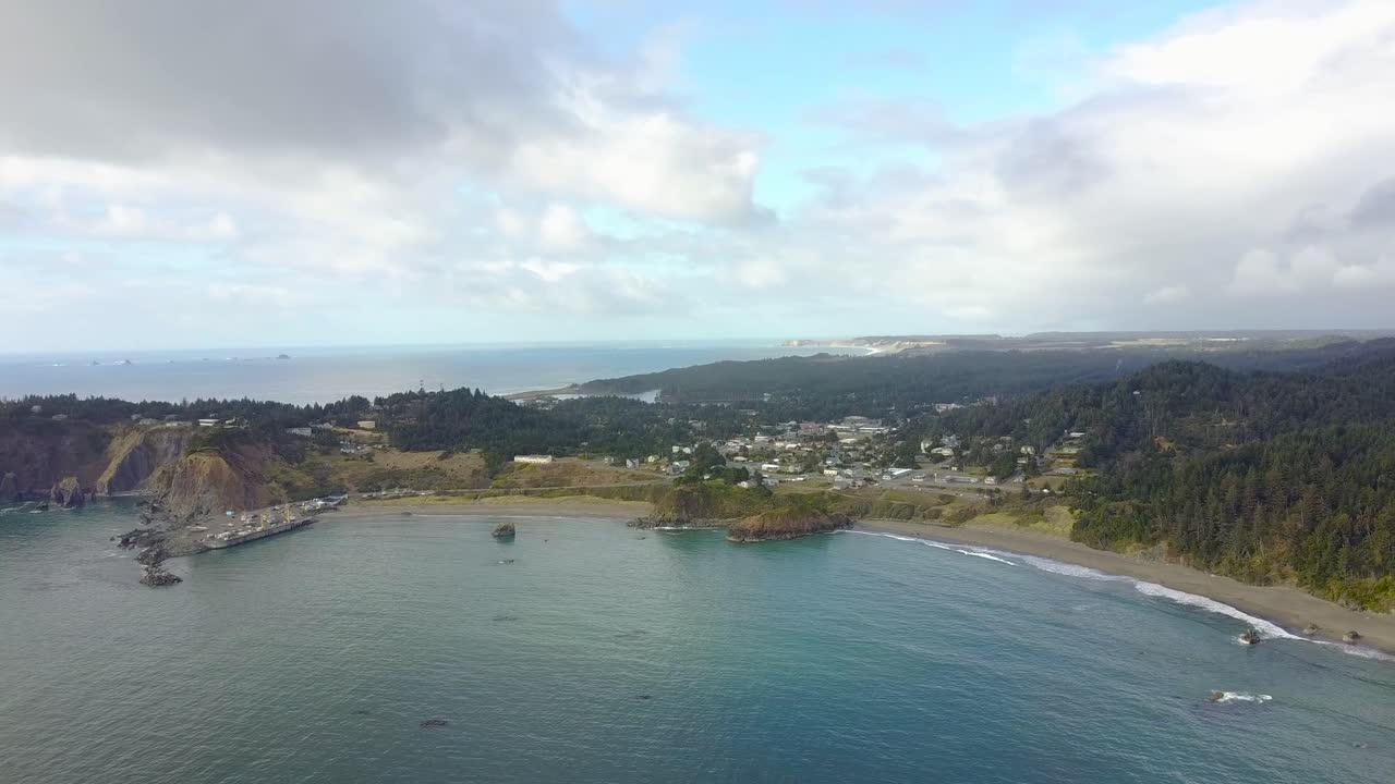 An aerial panning shot of a small seaside village.