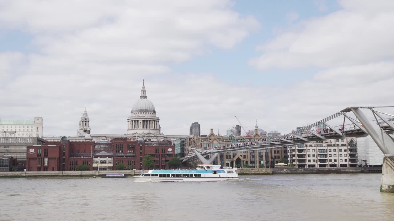 London Eye River Cruise boat and St. Pauls Cathedral in background, wide angle stable shot