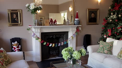 fireplace in a beautifully furnished home with christmas decorations including a christmas tree in the corner