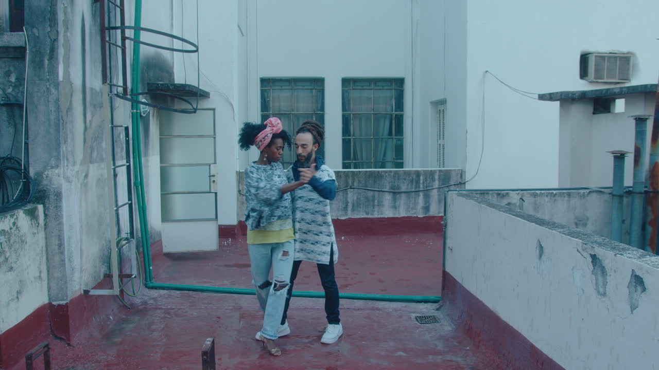 Couple Dancing Tango on a Rooftop in Poor Neighborhood