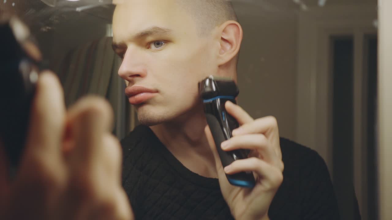 Caucasian Man Shaving In Front Of A Mirror - close up