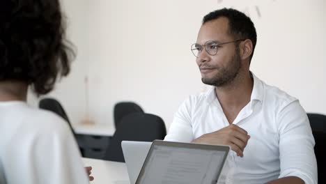 cheerful manager talking and shaking hands with clients