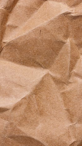 portrait stop motion loop of crumpled brown kraft wrap with soft shadows