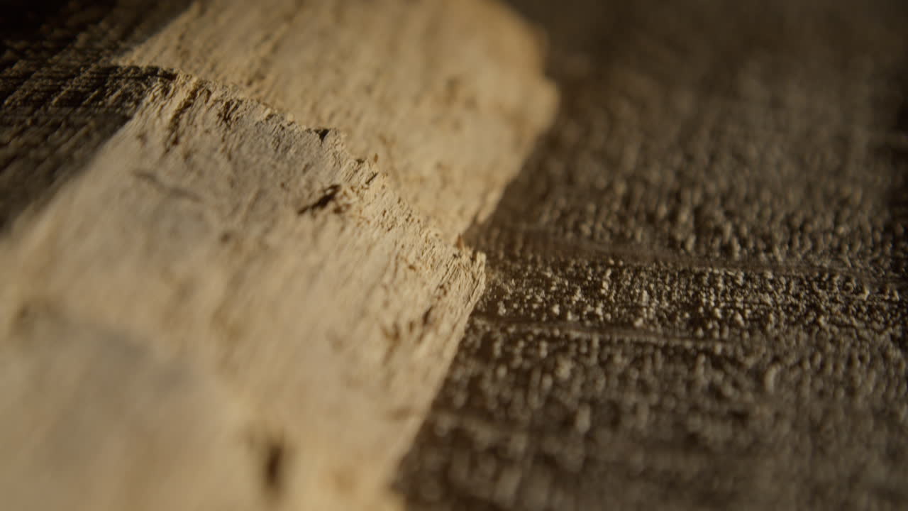 High quality video showing close up wooden surface with rich grain warm light and subtle texture captured in slow motion for a natural detailed and calm atmosphere