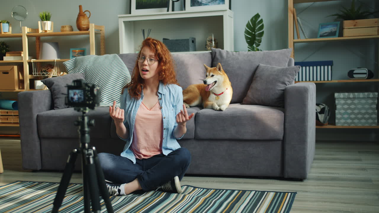 Woman vlogging with her dog in living room
