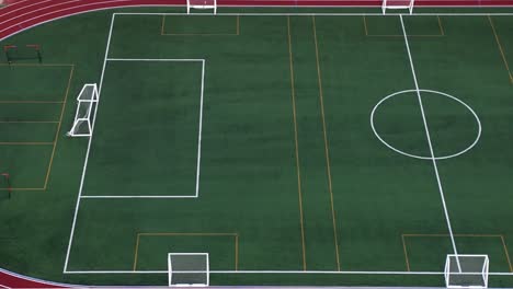 empty multipurpose football and athletics training field with synthetic grass