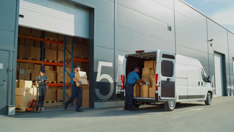 outside of logistics retailer warehouse with manager using tablet computer, diverse workers loading delivery truck with cardboard boxes. online orders, purchases, e-commerce goods. wide shot