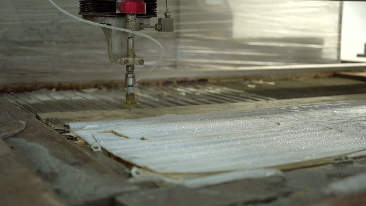 Cleaning the foam on the CNC water jet cutter with water pistol