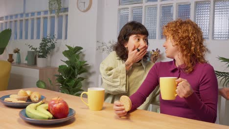 Two women having a snack and coffee