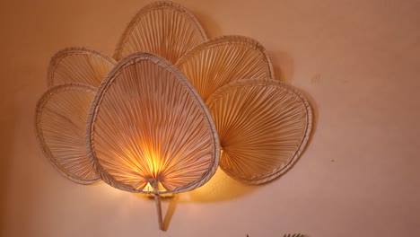elegant wall lamp with woven palm leaf fans