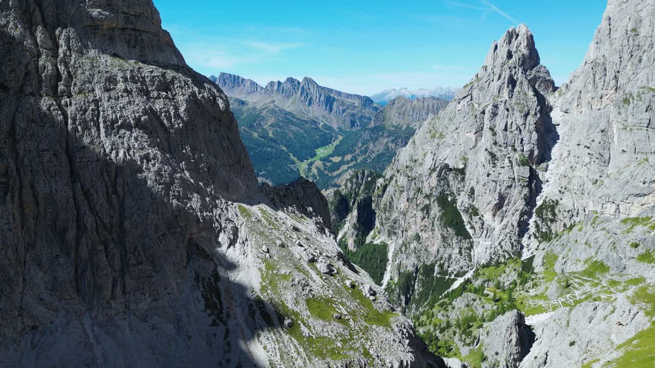 Drone footage of the Pale di San Martino in the Dolomites, Italy: majestic peaks, rocky spires, alpine meadows, and dramatic landscapes ideal for travel, nature, and adventure projects