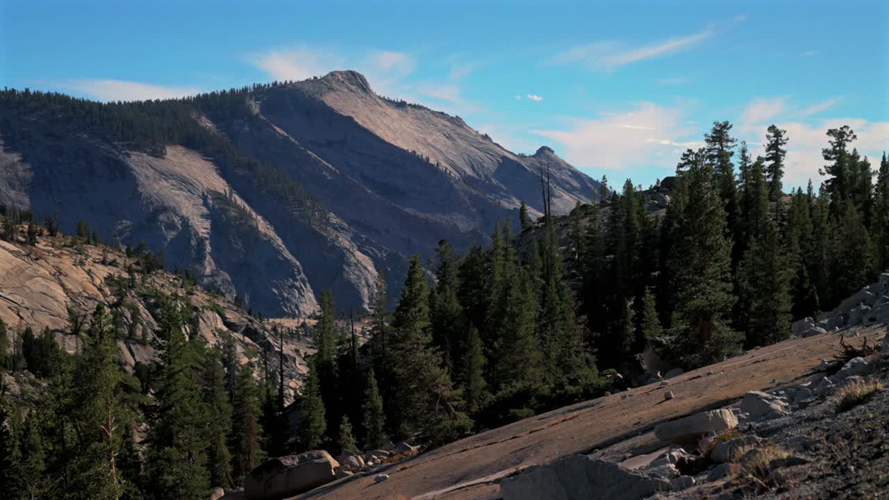 Tioga Pass Half Dome view Yosemite National Park West Portal entrance wilderness forest rugged rocky formation terrain California Lee Vining forest sunny blue sky Sierra Nevada Mountain nature static