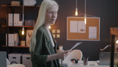 woman reading documents in modern office