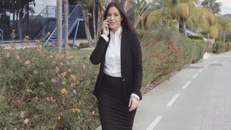 Busy-young-businesswoman-walking-along-a-street