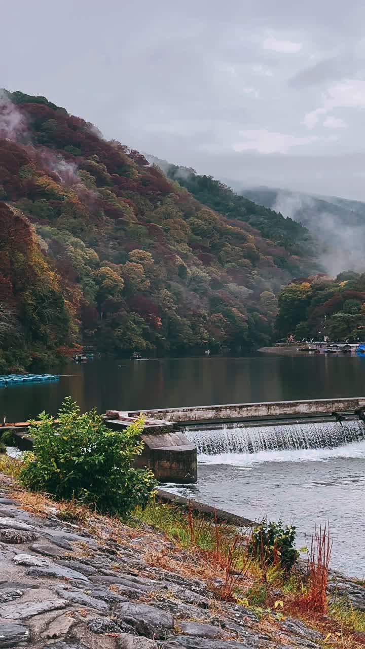 Autumn Scenery with Foggy Mountains and Waterfall