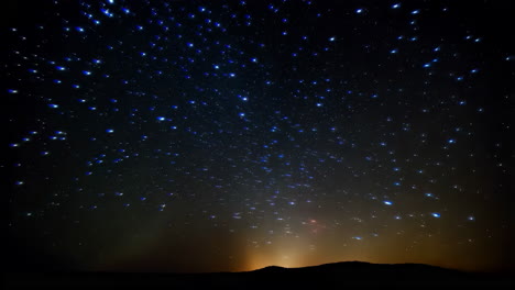 starry night sky over silhouette mountains