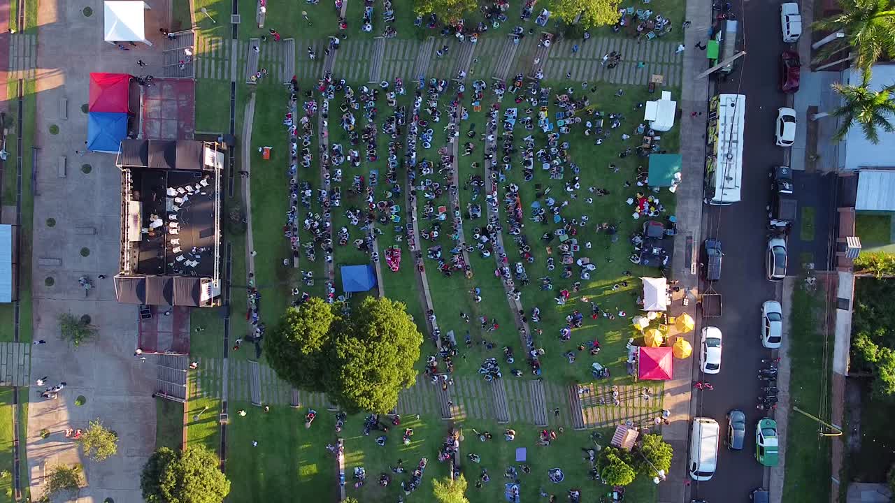 Aerial bird's eye drone shot of Posadas Anfiteatro El Brete festival in Argentina with concert and visitors
