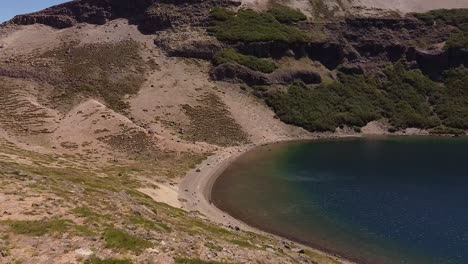 Revealing-aerial-of-the-lake-and-water-banks-in-the-mountains-of-Patagonia,-Argentina,-South-America