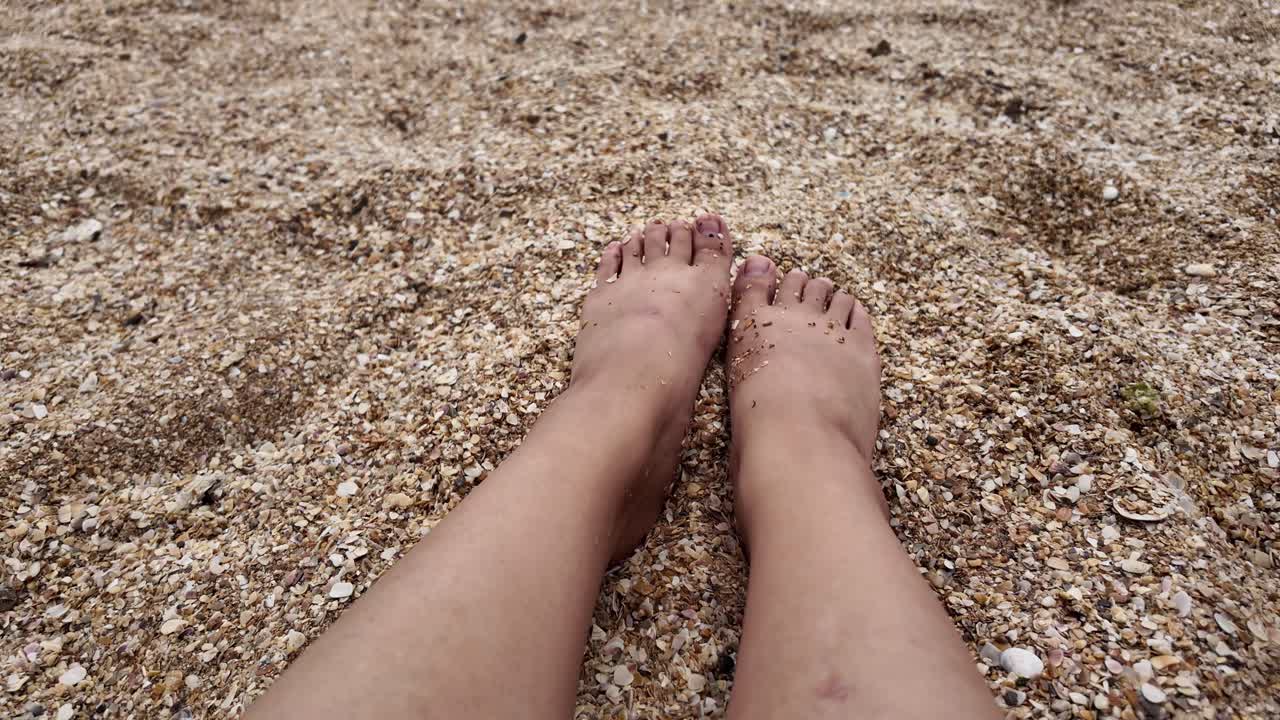Feet on a sandy beach