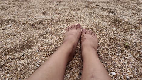 feet on a sandy beach