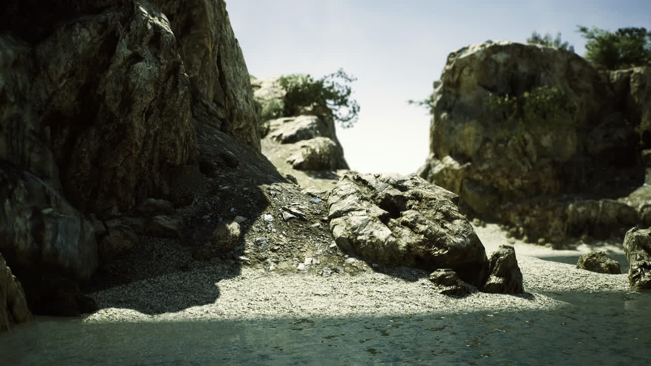 Coastal landscape with rocks and vegetation near calm water on sunny day