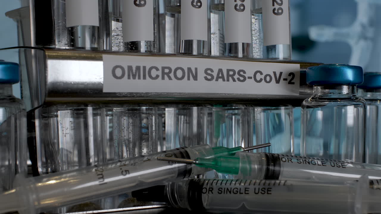A close up dolly shot of a laboratory rack labelled Omicron SARS-CoV-2, tracking backwards to reveal test samples, as the new strain of the Covid 19 pandemic raises healthcare concerns globally