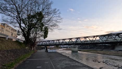 time-lapse of a bridge over a river during sunset