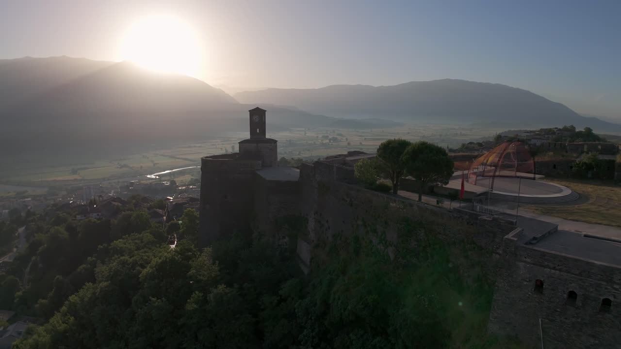 Castle of Gjirokastra, Albania. Morning Sun above hill, landscape with historical landmark. Drone