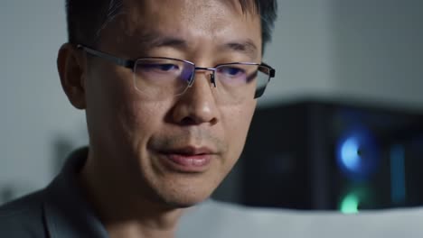 a focused individual analyzes important documents with intense concentration in a dimly lit environment, highlighting the depth of his engagement with the content