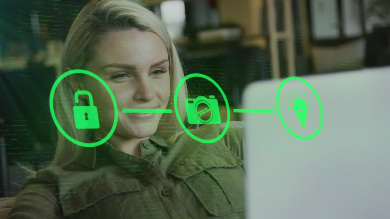 анимация икон и обработка данных над кавказской бизнесменкой, использующей ноутбук в офисе.