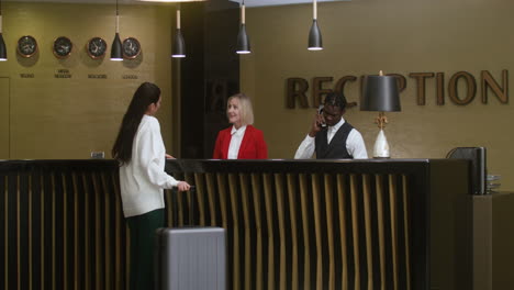 Young-woman-checking-in-at-the-hotel