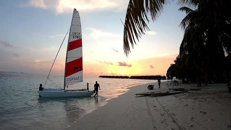 catamaran on a beach at sunset