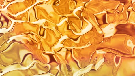 looped abstract background with wavy sparkling golden liquid pattern on shiny glossy surface. viscous yellow fluid like surface of gold foil or brilliant glass. beautiful creative festive backdrop.