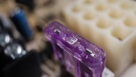 close up of a small 3 amp fuse on a circuit board with other electronic components