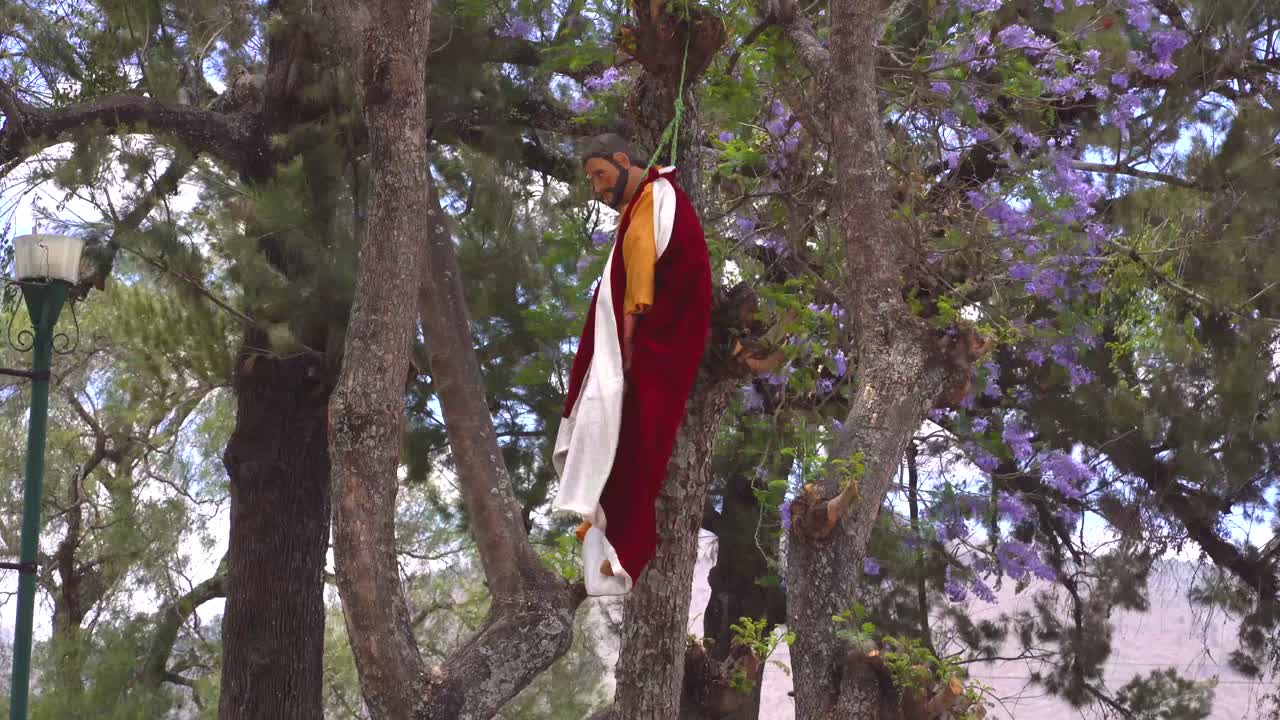 Figure of Judas hanging from tree. Holy week in La Merced , Antigua Guatemala. 2021