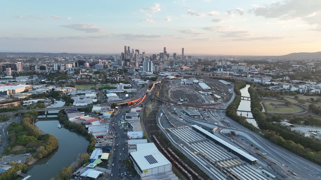 Establishing push in drone shot of Brisbane City, shot during sunset, flying over the inner city bypass ICB road network