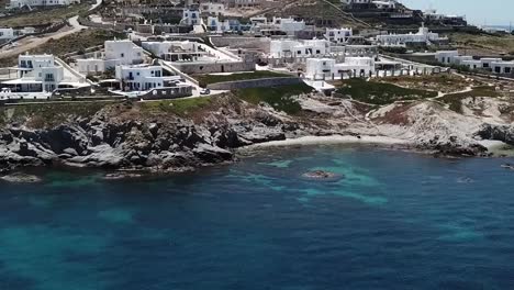 aerial drone moving forward pan down on blue beach mykonos